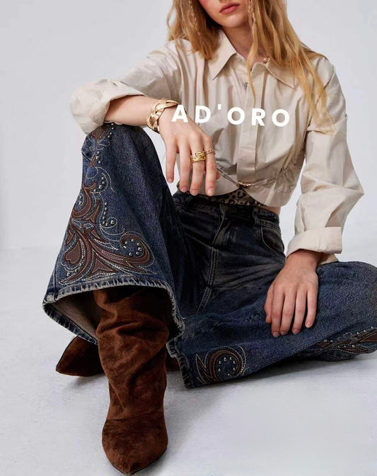 JEANS A PALAZZO CON EFFETTO PELLE E RICAMATA